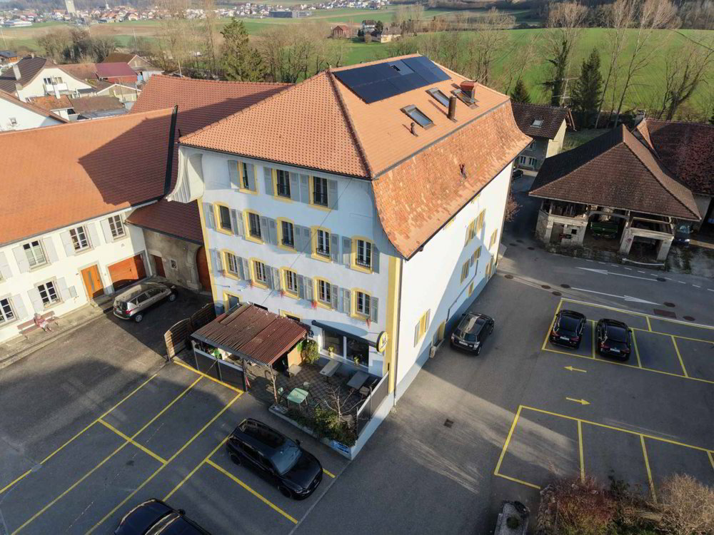 Immeuble d'habitation avec café-restaurant au coeur de la Broye